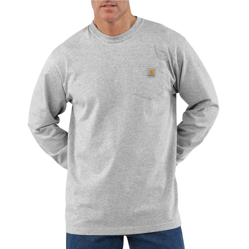 Man wearing a heather gray colored long sleeve shirt with a chest pocket against a white background. The chest pocket has a Carhartt logo on it. 