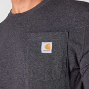 Close up of a man wearing a carbon heather colored shirt with a chest pocket against a white background. 