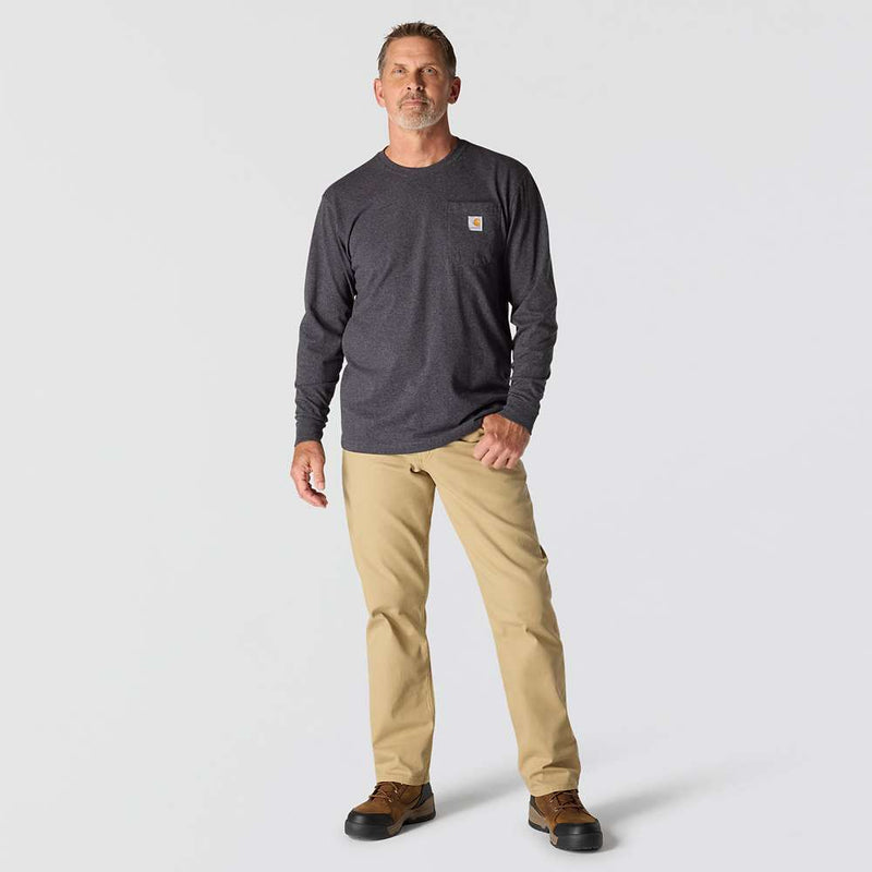 Man wearing a long sleeve carbon heather colored shirt with a chest pocket against a white background. The chest pocket has a Carhartt logo on it. 