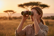 Woman looking through brown binoculars on a natural background.