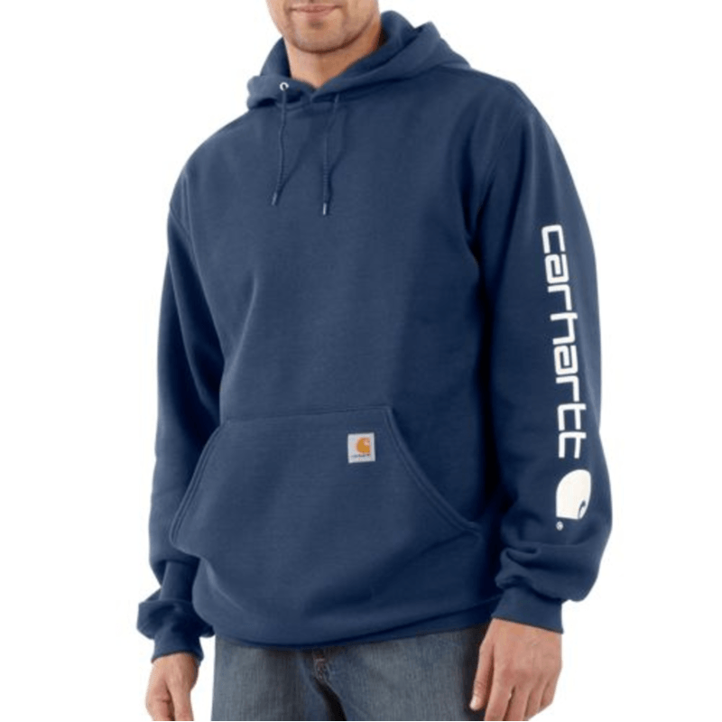 Person wearing a navy blue hoodie with Carhartt logo on a white background