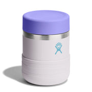 A Hydro Flask vacuum-insulated travel tumbler with a lavender purple lid, a light gray body, a silver stainless steel band, and a light blue Hydro Flask logo on the front, set against a plain white background.