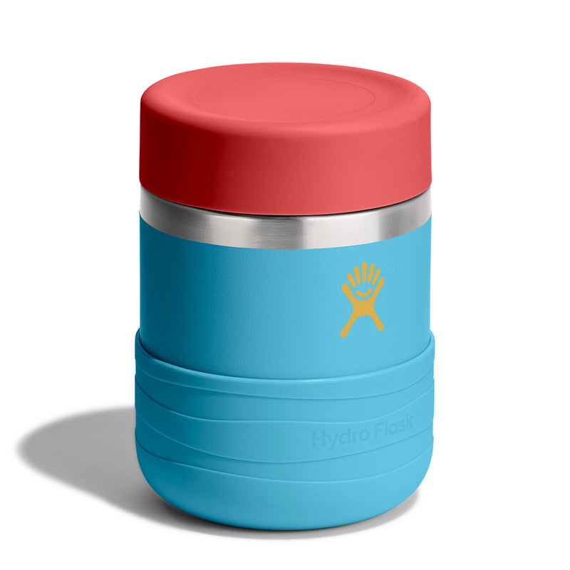 A Hydro Flask insulated tumbler with a bright blue body, a red lid, a stainless steel band, and a yellow logo on a white background.