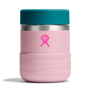 A Hydro Flask insulated tumbler with a light pink body, a teal lid, and a bright pink Hydro Flask logo on the front, set against a clean white background.