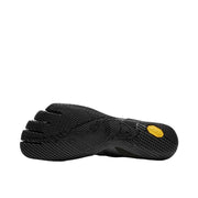Bottom view of the tread of a black and yellow climbing shoe against a white background.