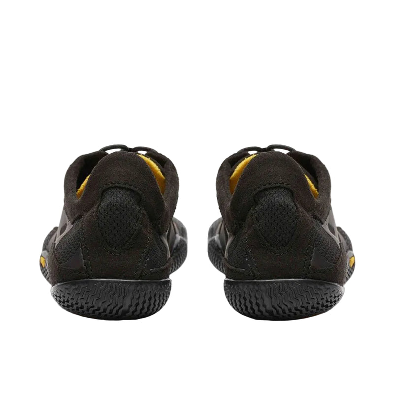 Back view of a pair of black and yellow climbing shoes against a white background. 