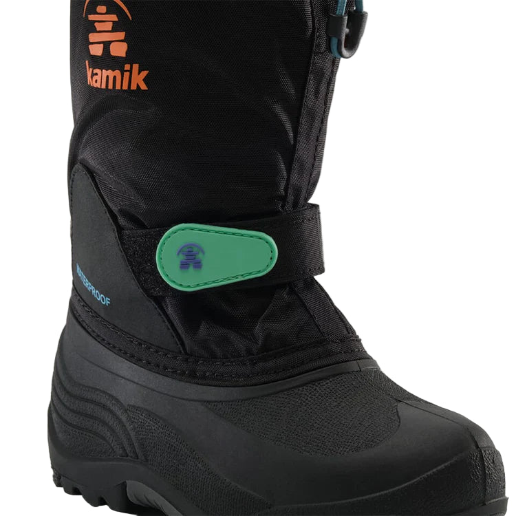 Black Kamik snow boot with a green patch on a light gray background