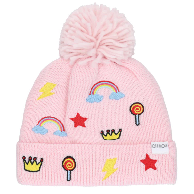 Pale pink colored kid's pom pom beanie with quirky designs against a white background. 