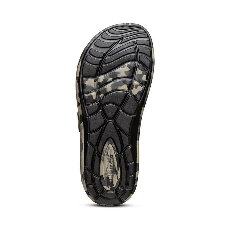 The black bottom of a camouflage sandal on a white background
