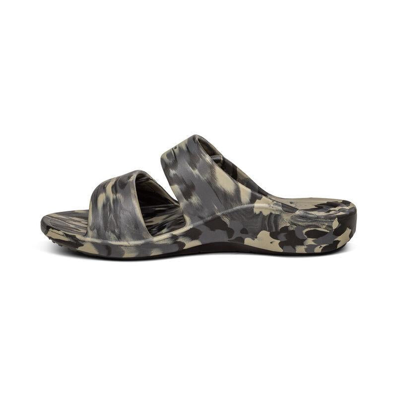 The side of a camouflage sandal with 2 straps on a white background