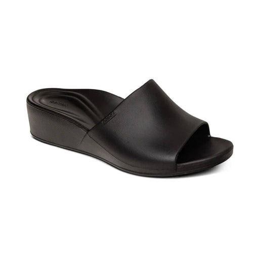 Side view of a black sandal against a white background. 