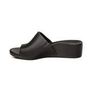 Side view of a black sandal against a white background. 