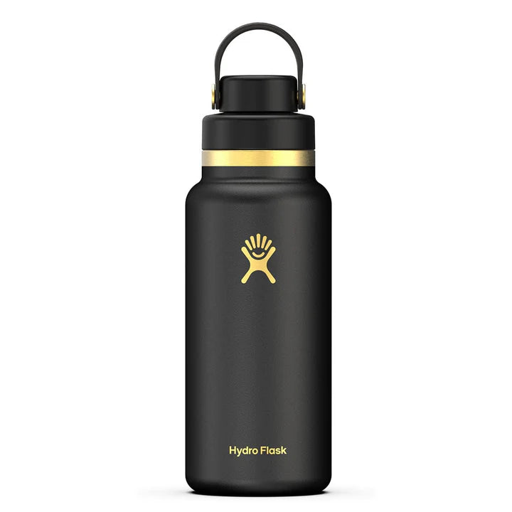Black Hydro Flask bottle with gold accents against a white background. 