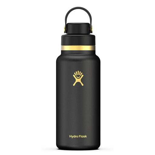 Black Hydro Flask bottle with gold accents against a white background. 