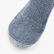Close-up of a blue sock with a textured pattern on a light gray background