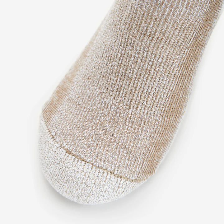 Close-up of a beige and white sock on a light gray background