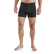 A man wearing black Carhartt men's boxer briefs, shown from the waist down against a plain white background.