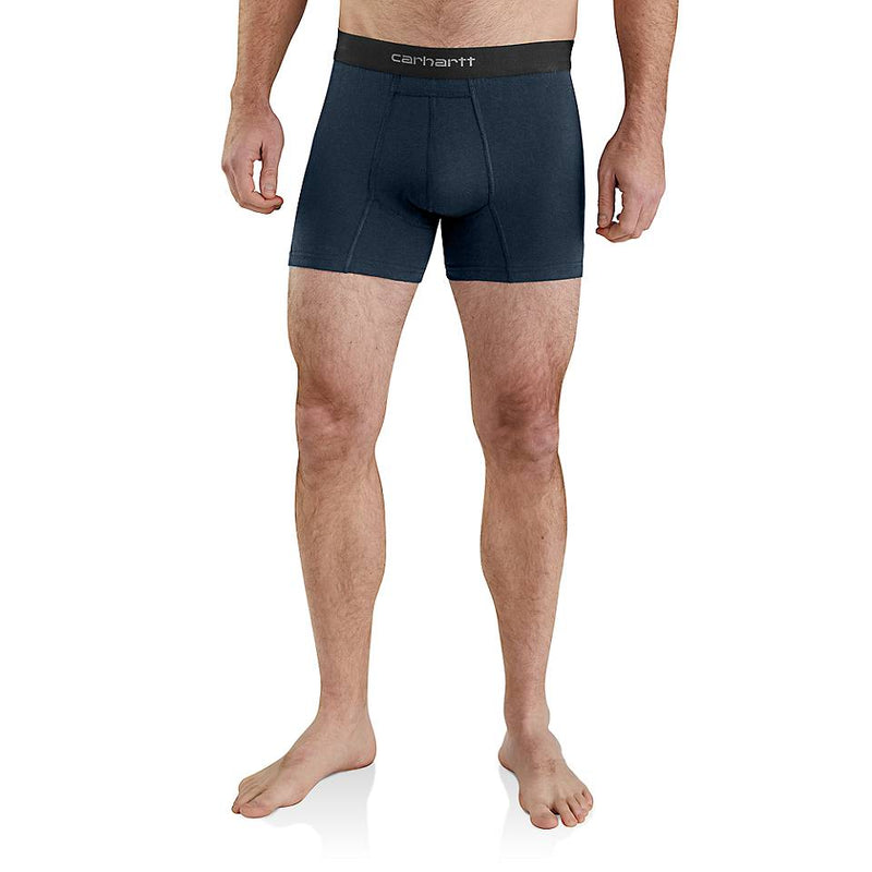 A man wearing dark navy blue Carhartt boxer briefs, shown from the waist down against a plain white background.