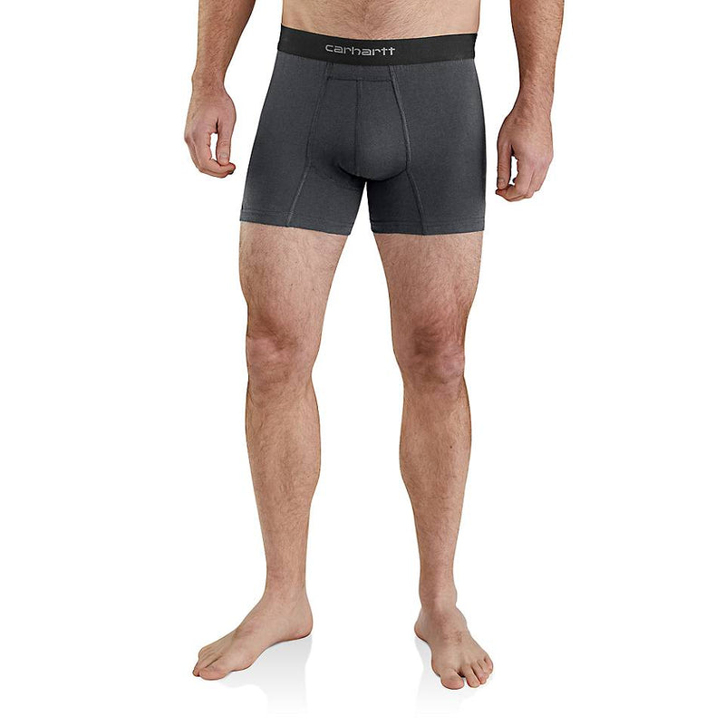 A man wearing dark gray Carhartt athletic boxer briefs, shown from the waist down against a plain white background.
