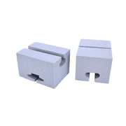 Two foam blocks with cutouts for canoe gunwales and roof rack rails, for carrying a canoe on the top of a car without a full rack. 