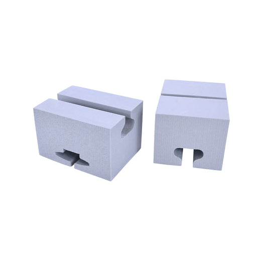 Two foam blocks with cutouts for canoe gunwales and roof rack rails, for carrying a canoe on the top of a car without a full rack. 