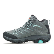 Left facing side-angle of a gray hiking boot with blue laces and blue and black accents on the sole against a white background. 