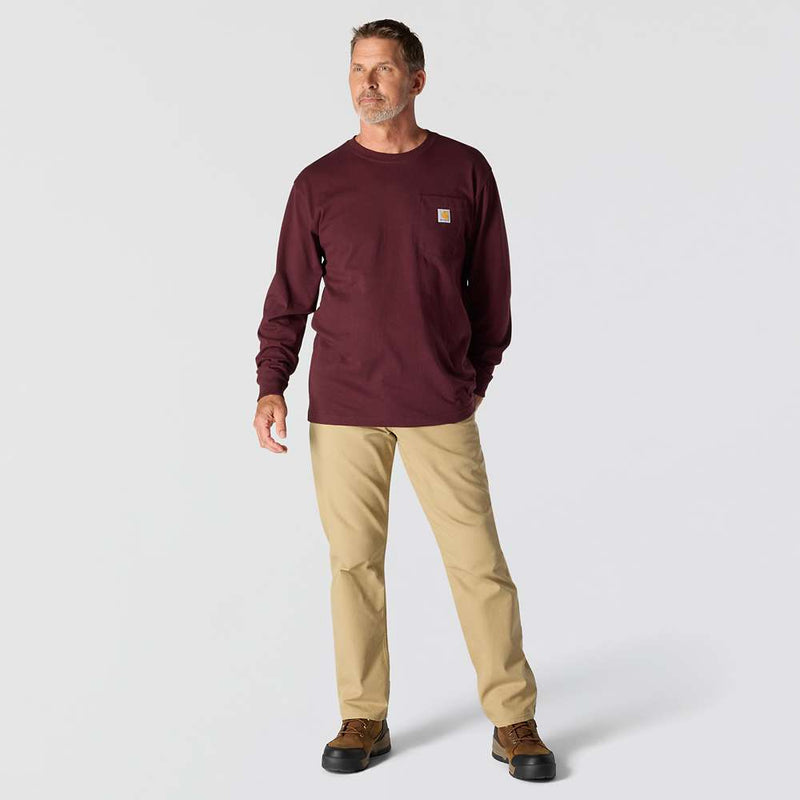 Man wearing a maroon long-sleeve shirt and beige pants on a white background