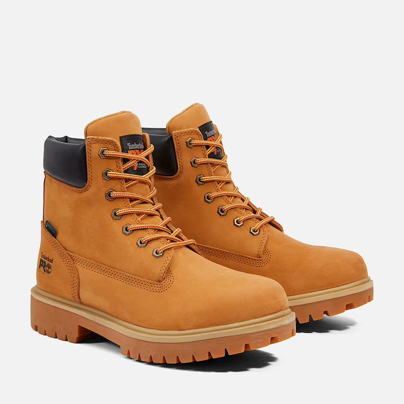 Pair of tan boots with orange laces on a white background
