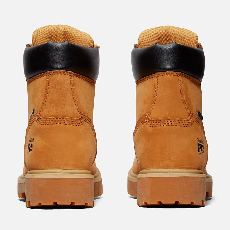 A pair of Timberland 6-inch work boots shown from the back, featuring a tan suede upper, black leather collar, and tan rubber sole on a light gray background.