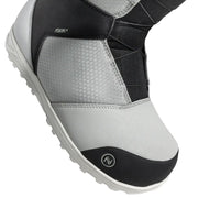 Close up of a grey snow boot with black accents against a white background. 