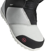 Close up of a gray snow boot with black accents and a pink Nidecker logo against a white background. 