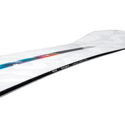 Side view of a white snowboard with a black stripe going down the side of it with a Nidecker logo on it against a white background. 