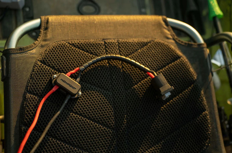 Battery cable laid against a black chair.