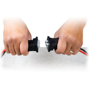 Two hands disconnecting cables on a white background.