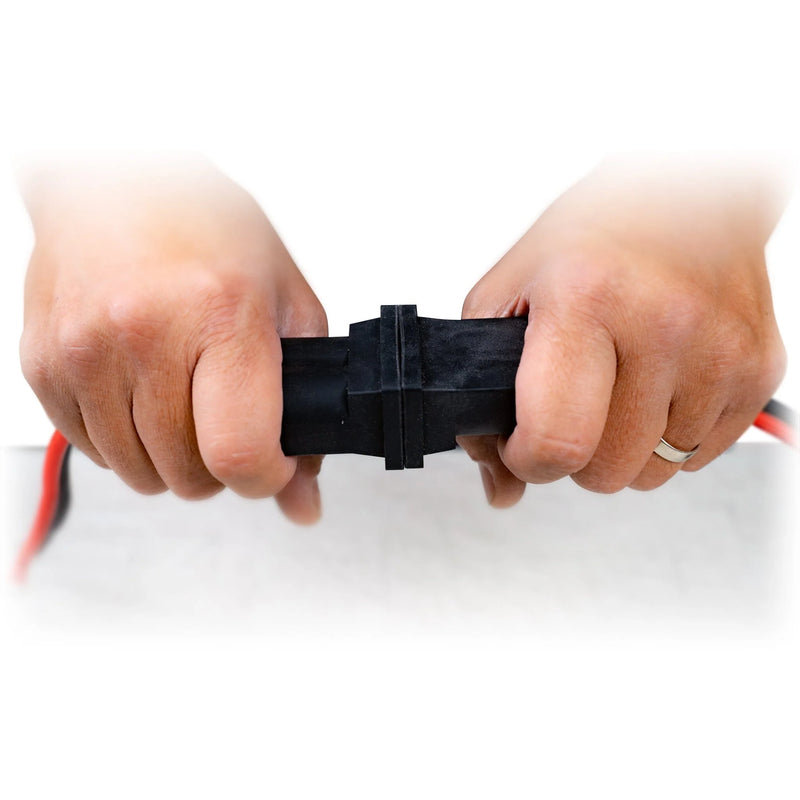 Two hands attaching cables together on a white background.