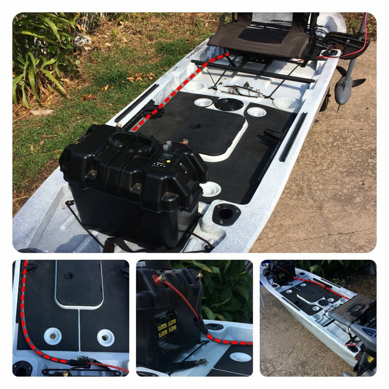 Black battery pack attached to a white boat with grass and pavement in the background.