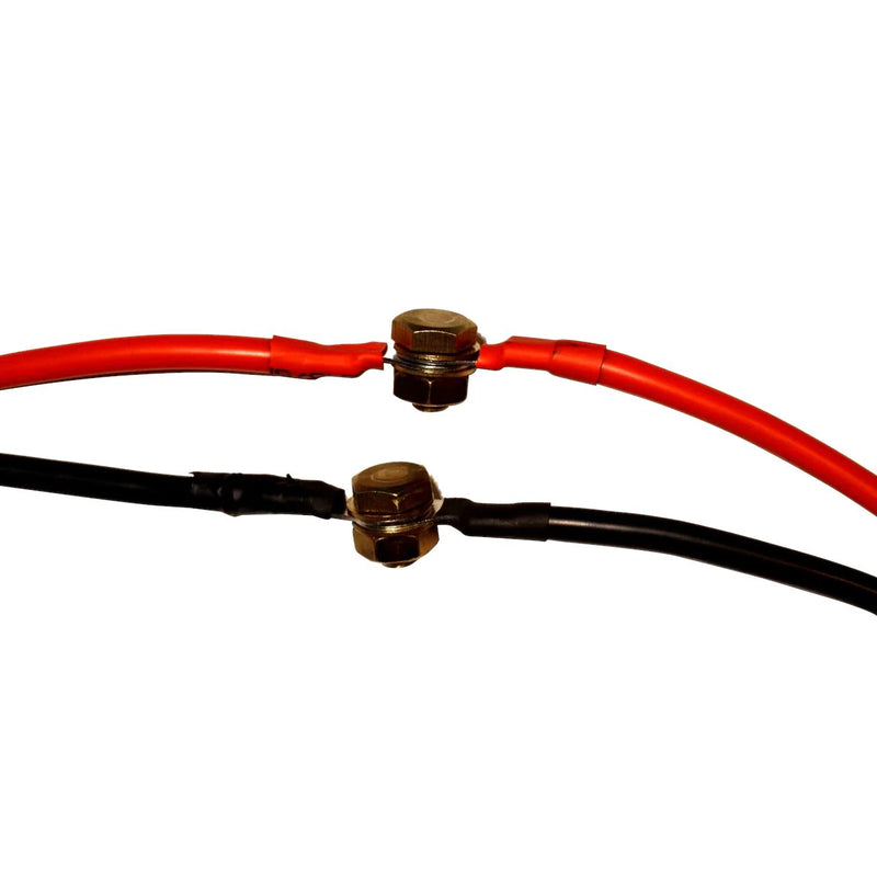 Close up image of red and black cables on a white background.