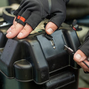 A person plugging a USB cord into a battery box.