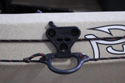 Black anchor trolley attached to a tan boat.