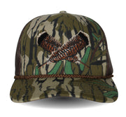 Camouflage cap with a feather motif on a white background.