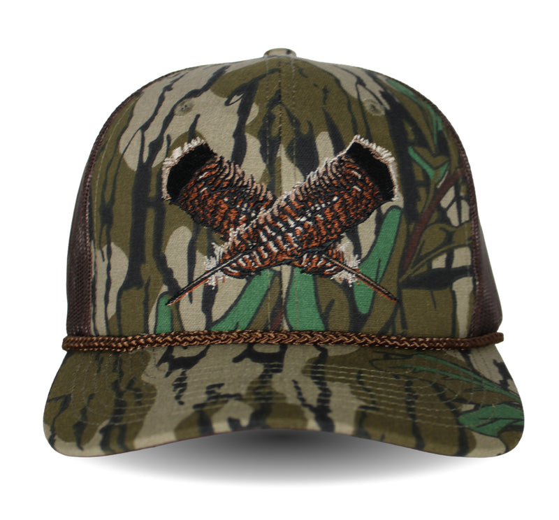 Camouflage cap with a feather motif on a white background.