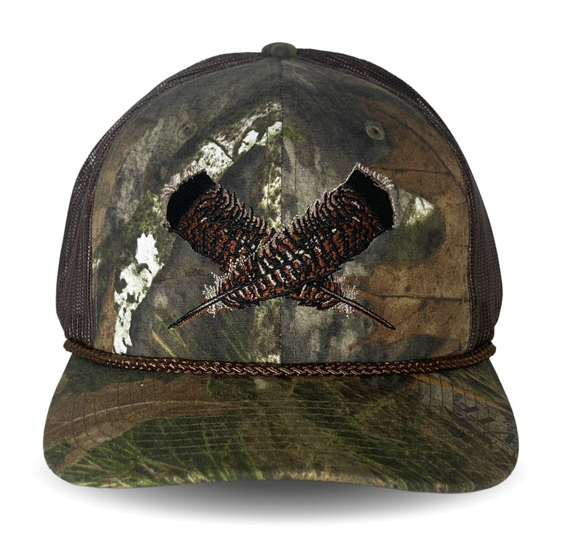 Camouflage cap with a feather motif on a white background.