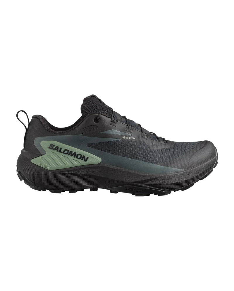 Black Salomon running shoe on a light gray background