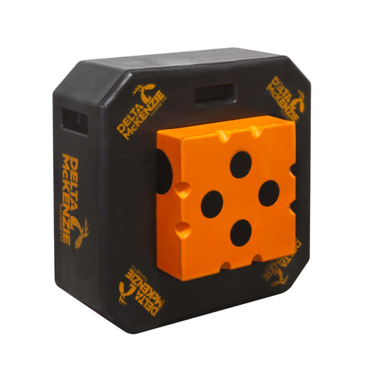 A Delta McKenzie target featuring a black octagonal body with a prominent orange dice-face insert, shown on a plain white background.