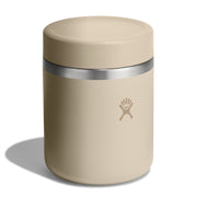 A beige insulated food jar with a matching lid and a silver metal band, featuring the Hydro Flask logo on the front, set against a plain white background with a soft shadow.