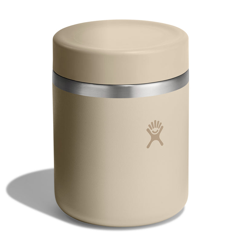 A beige insulated food jar with a matching lid and a silver metal band, featuring the Hydro Flask logo on the front, set against a plain white background with a soft shadow.