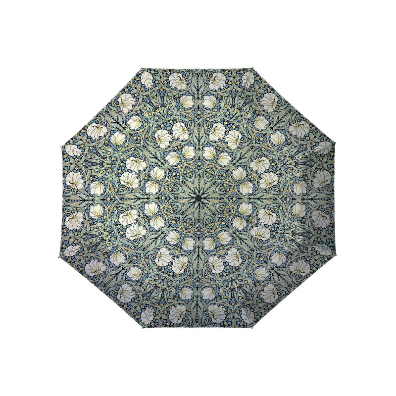 An umbrella with a blue and green floral pattern on a white background