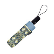 A closed umbrella with a blue and green floral pattern on a white background