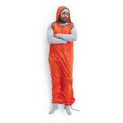 Person wearing an orange sleeping bag liner on a white background