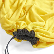 Yellow drawstring sleeping bag liner with a black drawstring on a white background
